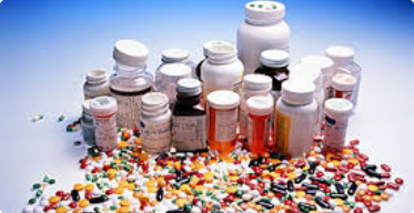 Medicine bottles surrounded by medicine tablets and capsules